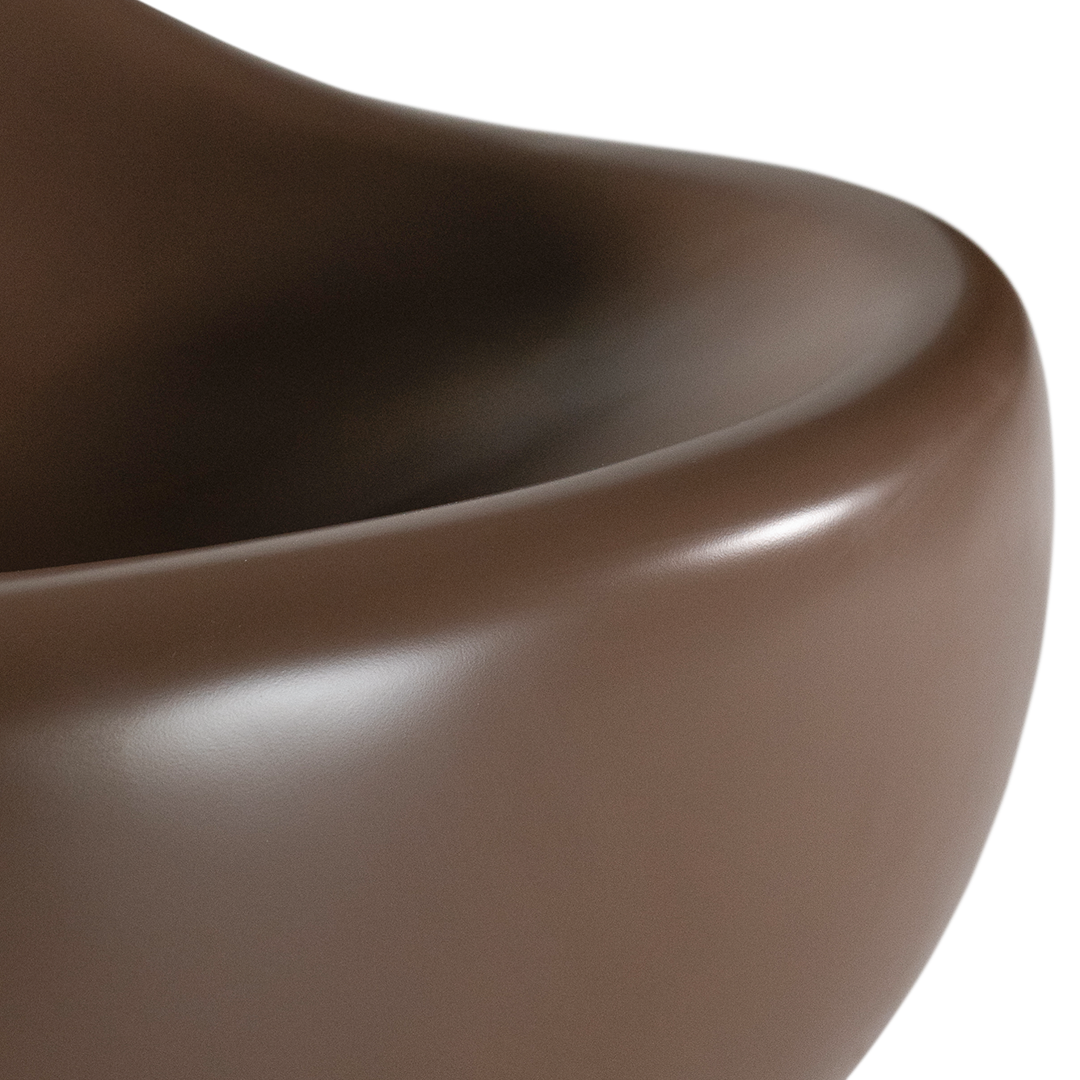 Santorini occasional chair in chocolate featuring a smooth sculptural form with rounded curves and a deep comfortable seat.