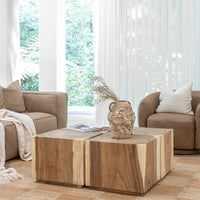 Modern organic living room featuring a solid wood coffee table with a natural finish, complemented by plush leather sofas and a textured neutral rug for a warm, inviting ambiance