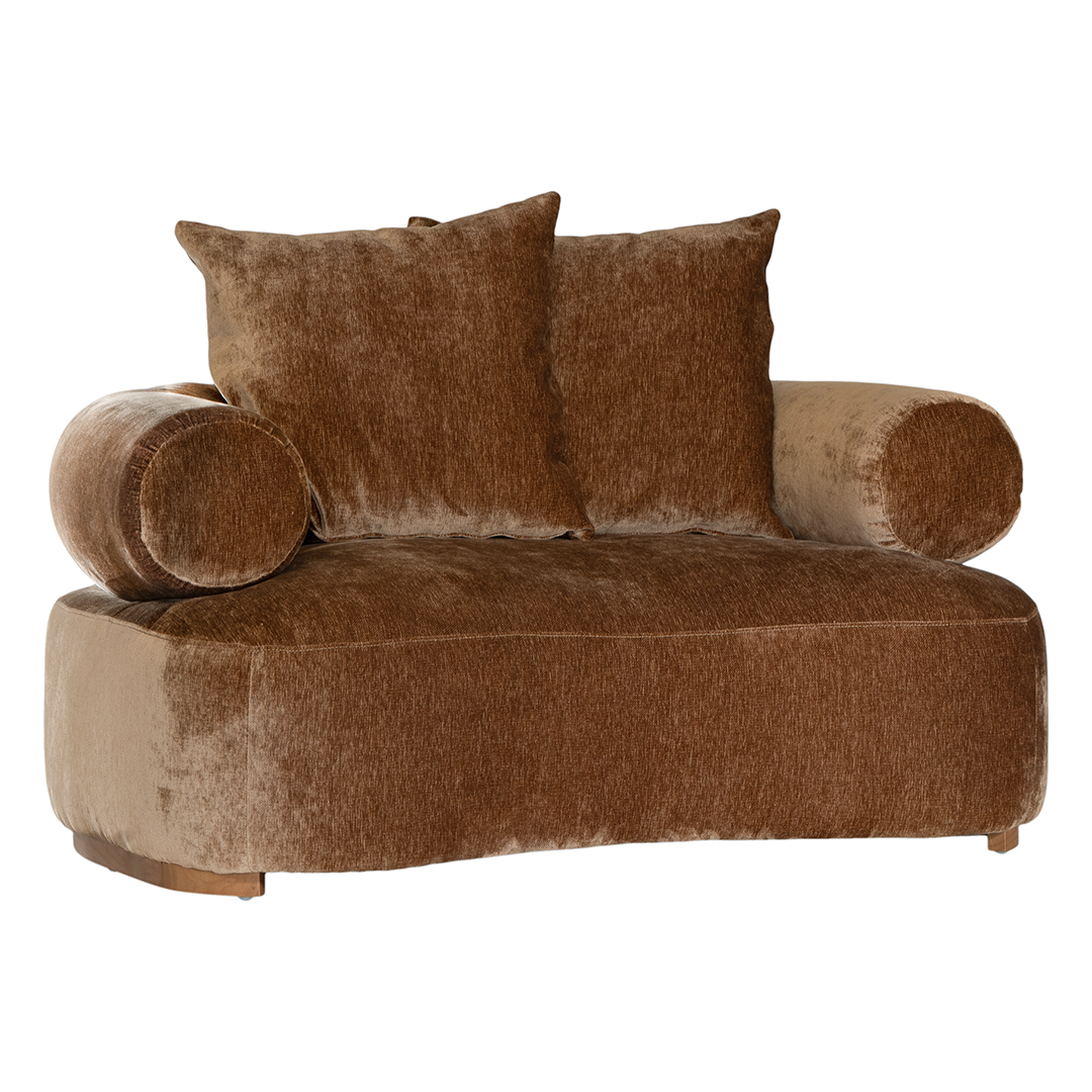 Soneva one seater sofa in bronze fabric featuring a soft curved silhouette with round bolster cushions and plush back pillows.