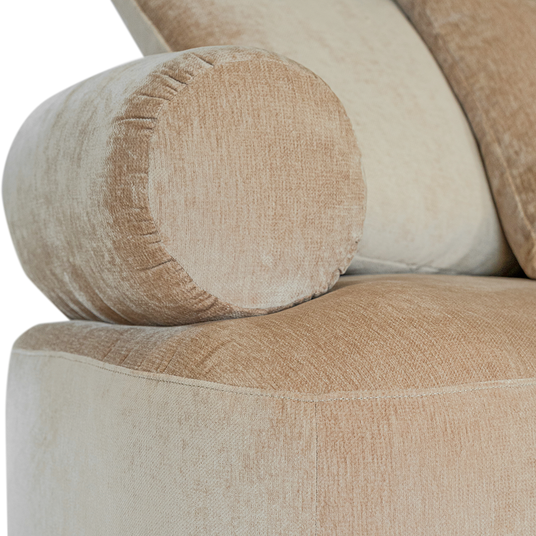 Soneva one seater sofa in dolce fabric featuring a soft curved silhouette with round bolster cushions and plush back pillows.