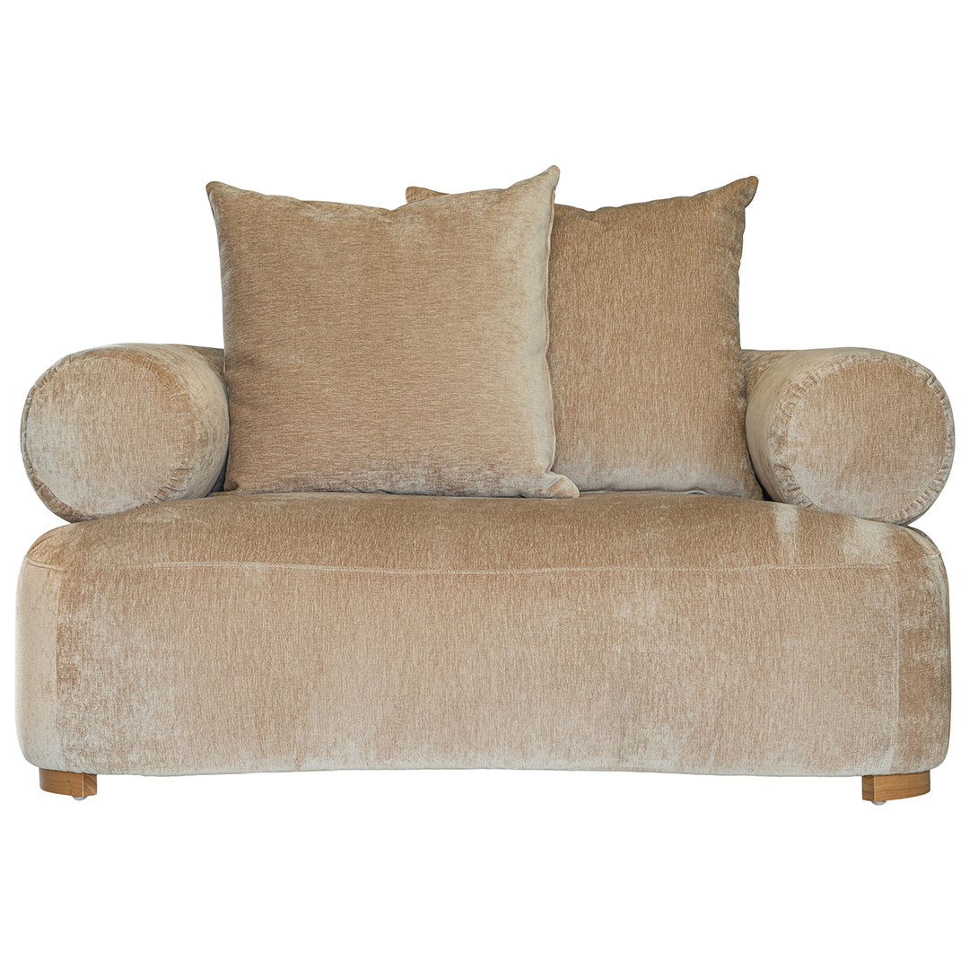 Soneva one seater sofa in dolce fabric featuring a soft curved silhouette with round bolster cushions and plush back pillows.