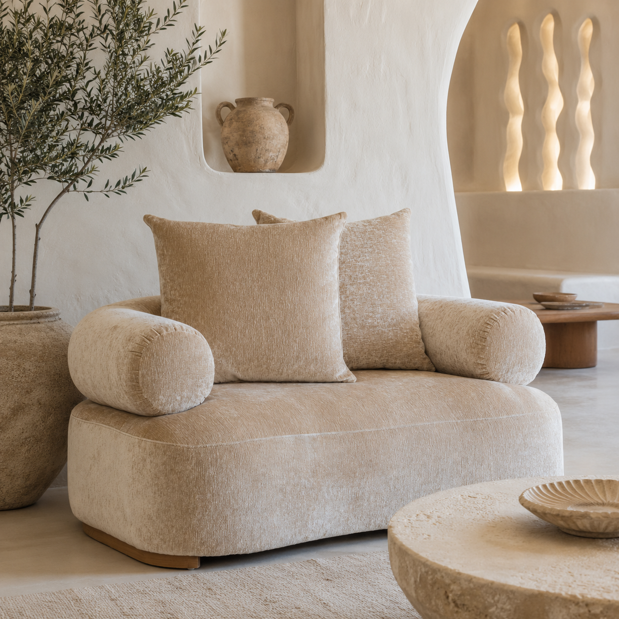 Soneva sofa in Dolce featuring soft curved arms and plush textured upholstery styled in a serene Mediterranean inspired living room.
