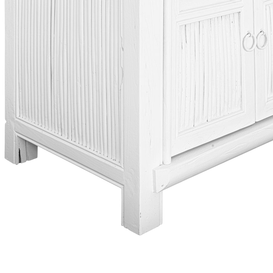 White bamboo entertainment unit with six panelled doors, featuring fine natural rattan detailing and minimal white ring handles.