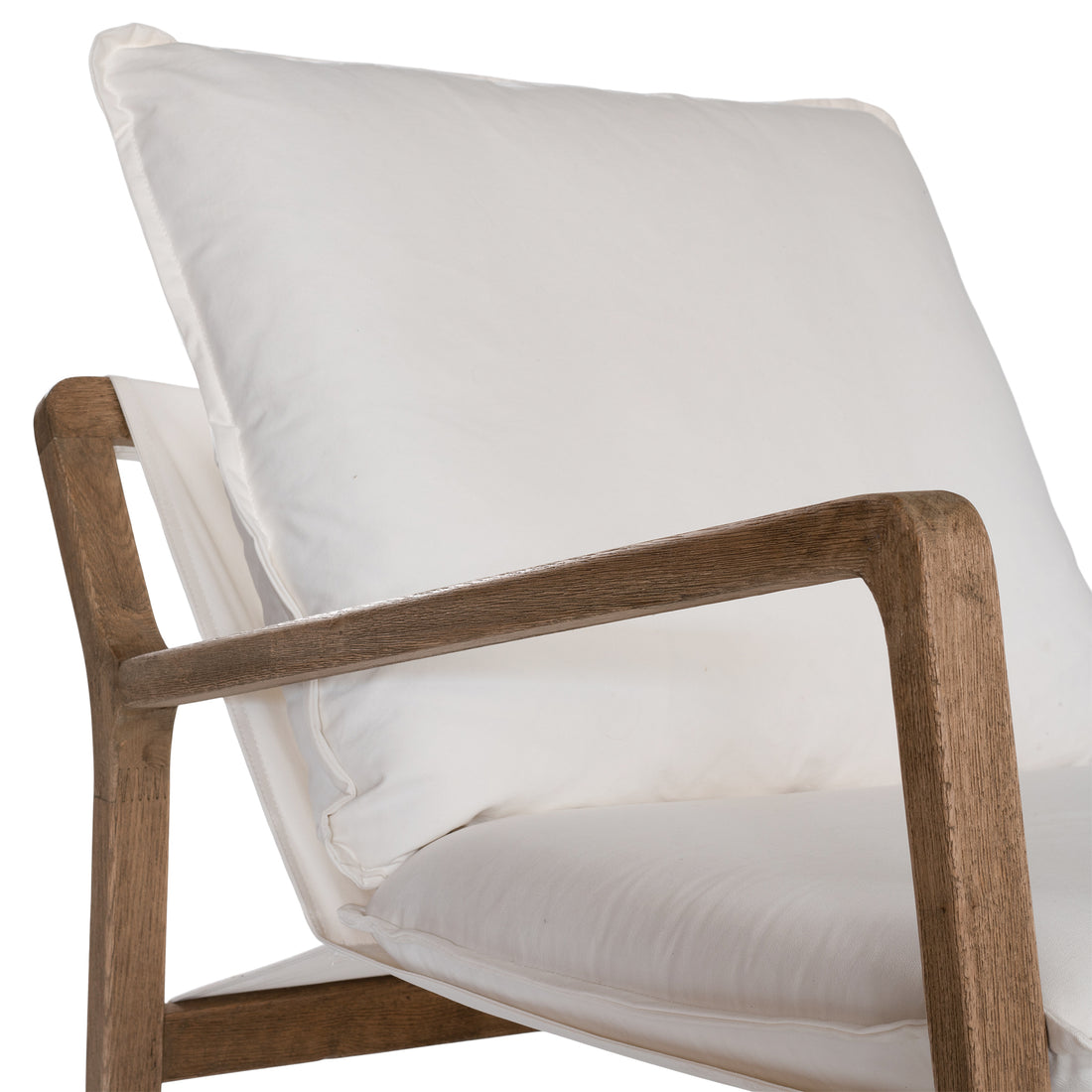 Barbuda Occasional Chair by Uniqwa Collections featuring white cushions and a curved driftwood frame in a relaxed resort-style silhouette.