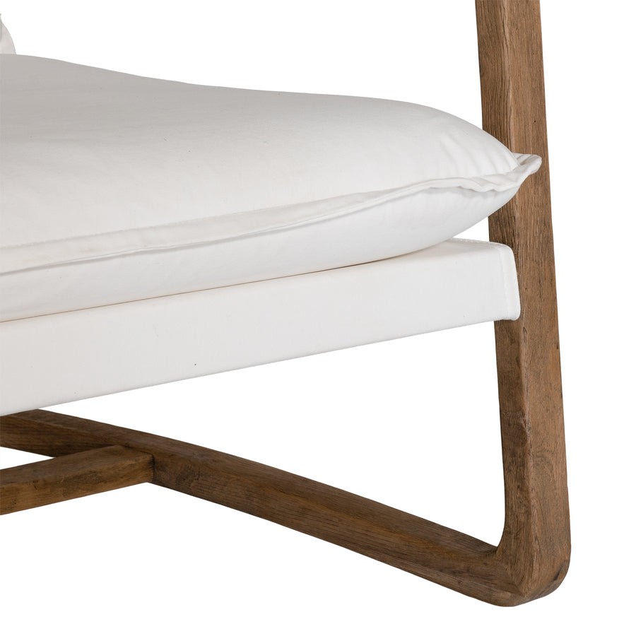 Barbuda Occasional Chair by Uniqwa Collections featuring white cushions and a curved driftwood frame in a relaxed resort-style silhouette.